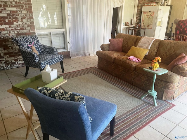 living room with brick wall and light tile patterned floors