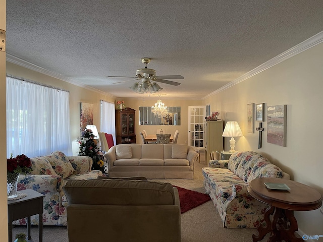 living room with ceiling fan, ornamental molding, carpet floors, and a textured ceiling