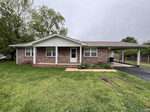 ranch-style house with a front lawn, covered porch, brick siding, driveway, and a carport