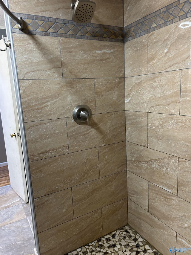 bathroom with a tile shower