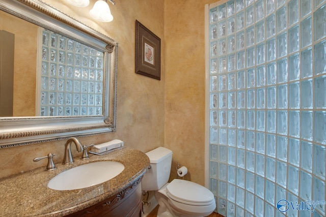 half bathroom with vanity and toilet