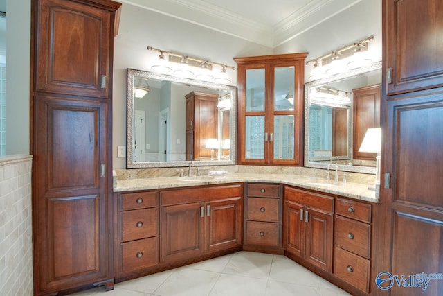 bathroom with double vanity, ornamental molding, a sink, and tile patterned floors