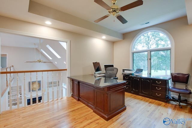 home office with light wood finished floors, recessed lighting, visible vents, lofted ceiling with skylight, and a ceiling fan