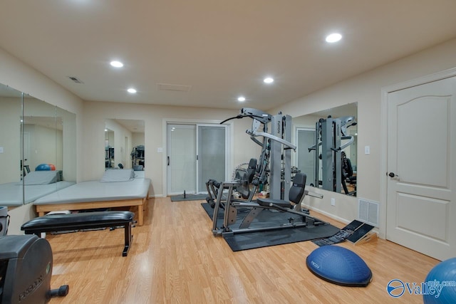 exercise room with visible vents, wood finished floors, and recessed lighting