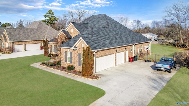 view of front of home with a garage, brick siding, fence, roof with shingles, and a front lawn