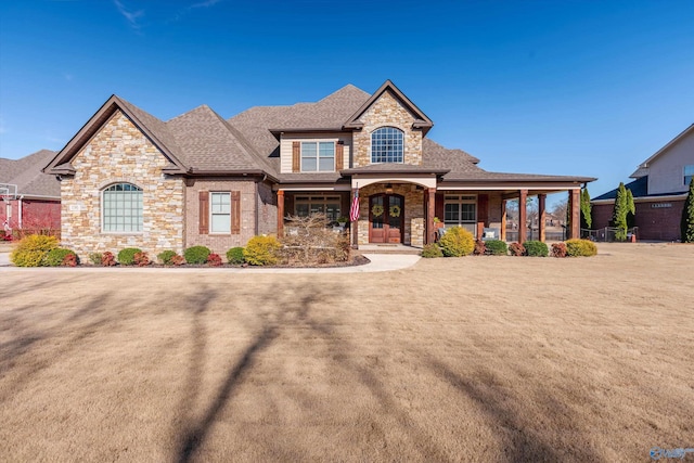 view of front of home with a porch, french doors, and roof with shingles