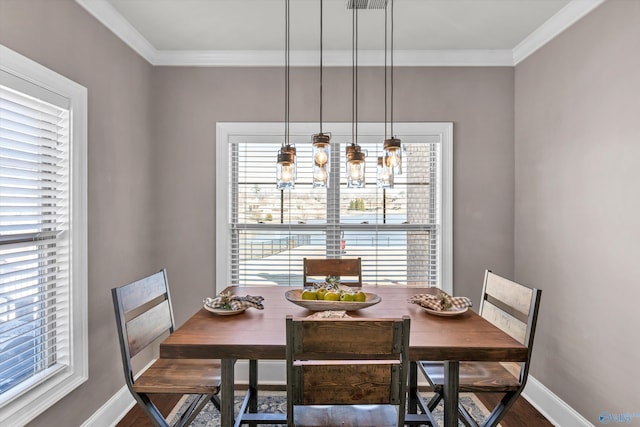 dining space featuring baseboards, ornamental molding, and dark wood-style flooring