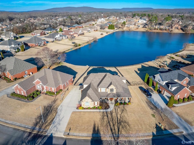 birds eye view of property with a water and mountain view and a residential view