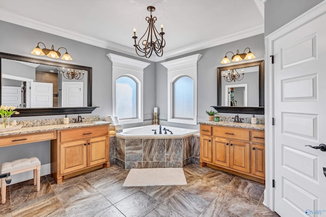 full bathroom featuring a garden tub, a notable chandelier, a sink, two vanities, and ornamental molding