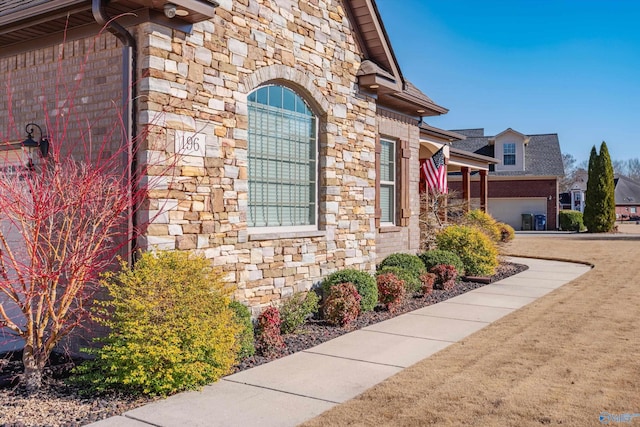 view of side of home with stone siding and brick siding