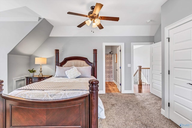 bedroom with ensuite bathroom, carpet flooring, a ceiling fan, and baseboards