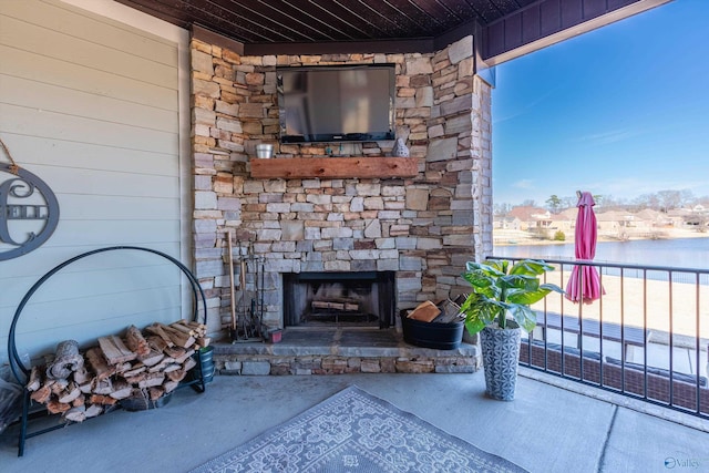 view of patio featuring an outdoor stone fireplace