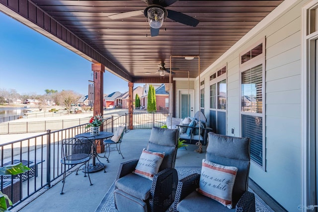 view of patio / terrace with a ceiling fan and a balcony