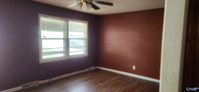 empty room featuring ceiling fan and dark hardwood / wood-style flooring