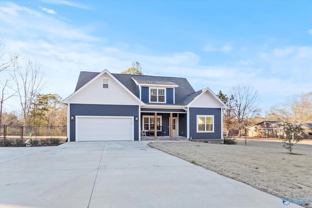 traditional-style house with a garage, fence, a porch, and concrete driveway