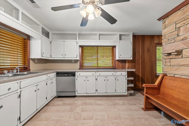 kitchen featuring ceiling fan, white cabinets, sink, dishwasher, and light tile patterned floors