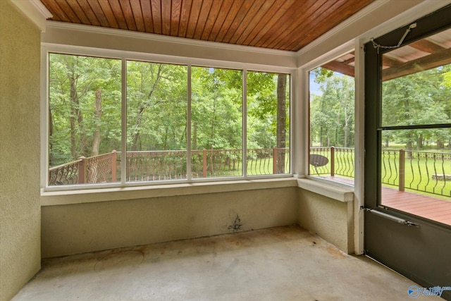 unfurnished sunroom featuring a healthy amount of sunlight and wood ceiling