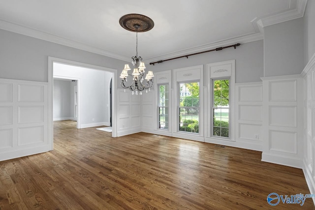 2600 Treyburne Ln, Hampton Cove, AL 35763 - unfurnished dining area featuring a chandelier, a decorative wall, ornamental molding, and wood finished floors