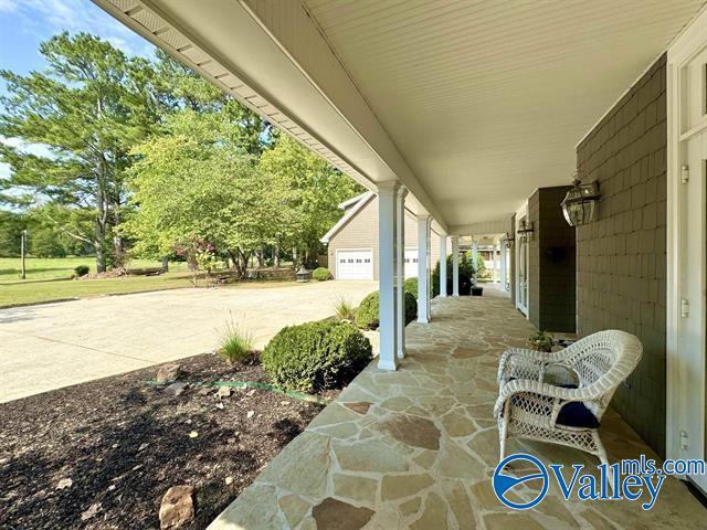 view of patio with a garage and covered porch