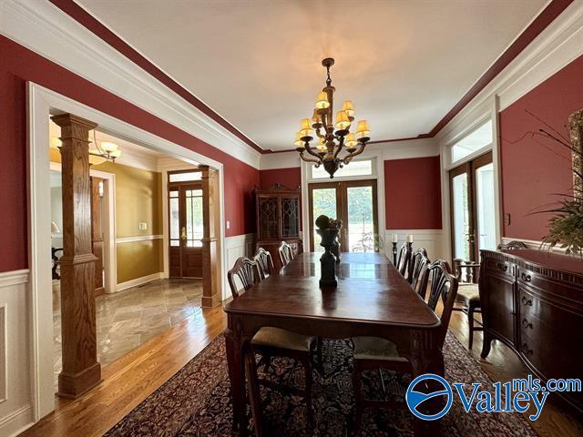 dining room featuring a wainscoted wall, a wealth of natural light, and french doors