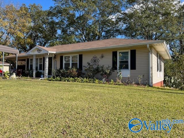 single story home with a carport and a front yard