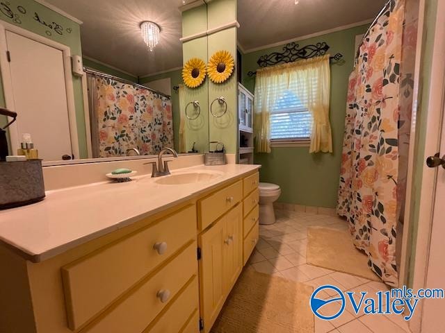 bathroom featuring tile patterned flooring, vanity, toilet, and ornamental molding