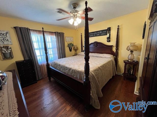 bedroom with ceiling fan and dark hardwood / wood-style flooring