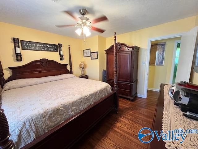 bedroom featuring ceiling fan and dark wood-type flooring