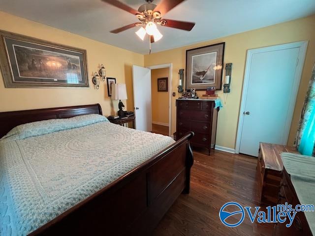 bedroom featuring dark hardwood / wood-style floors and ceiling fan