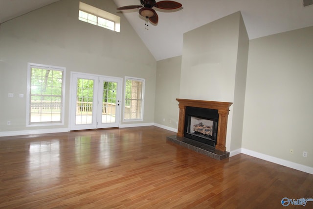 730 John Cabaniss Rd, Langston, AL 35755 - unfurnished living room with a fireplace with raised hearth, high vaulted ceiling, a ceiling fan, baseboards, and wood finished floors