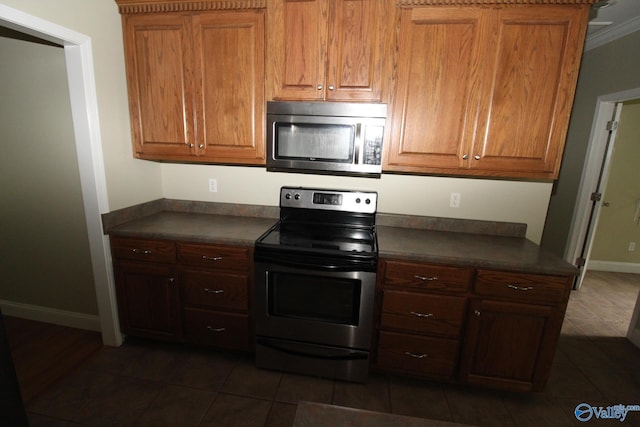 730 John Cabaniss Rd, Langston, AL 35755 - kitchen with appliances with stainless steel finishes, dark countertops, dark tile patterned flooring, and baseboards