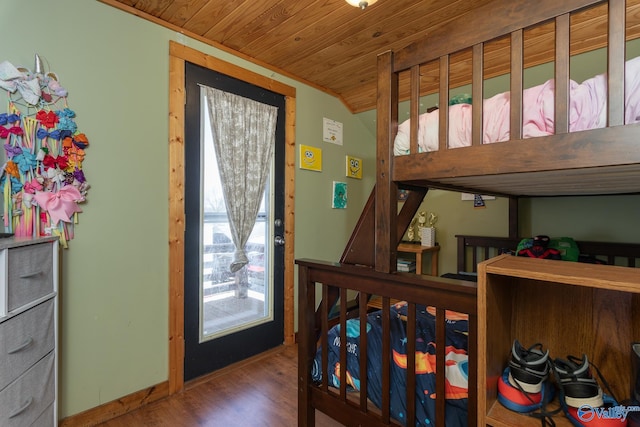 bedroom with hardwood / wood-style flooring and lofted ceiling