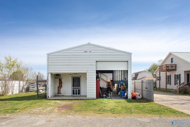 exterior space with a yard and an AC wall unit