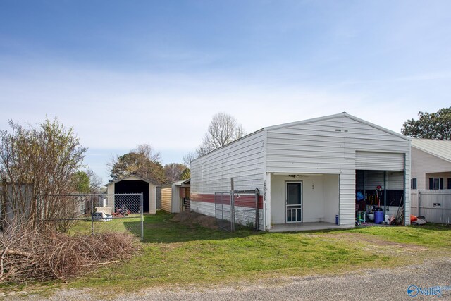 view of side of home with an outbuilding and a lawn