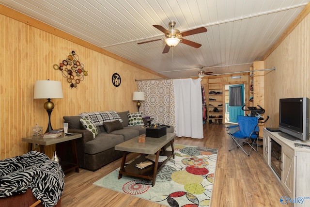 living room with wooden walls, light hardwood / wood-style floors, and wood ceiling