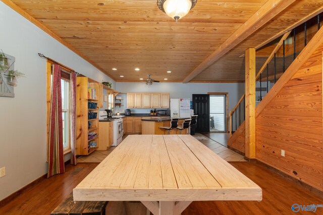 kitchen featuring range with gas stovetop, light hardwood / wood-style flooring, light brown cabinets, a center island, and wooden ceiling