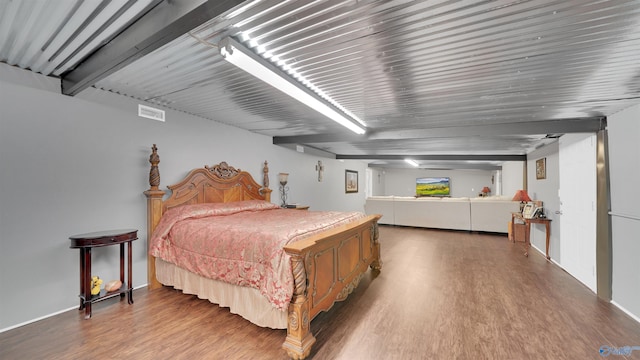 bedroom with visible vents and wood finished floors