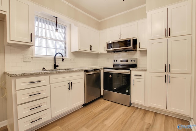 kitchen with light hardwood / wood-style flooring, sink, stainless steel appliances, and white cabinetry