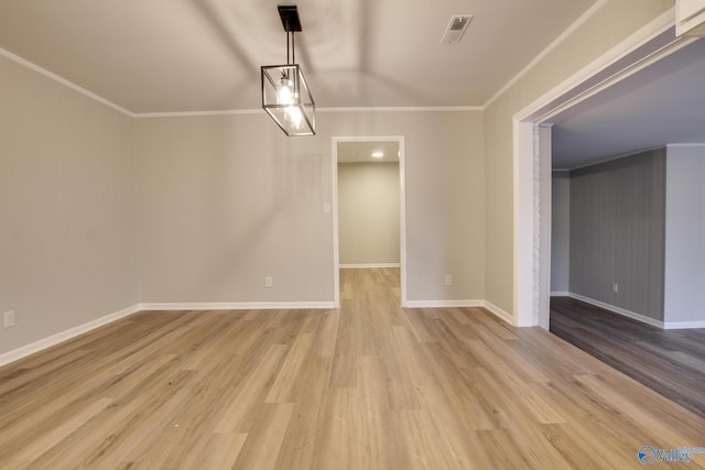 unfurnished dining area featuring crown molding and light hardwood / wood-style floors