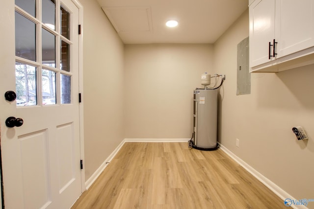 entryway featuring water heater, electric panel, and light hardwood / wood-style flooring