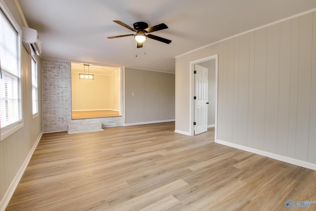 unfurnished room featuring ceiling fan, crown molding, light hardwood / wood-style flooring, and a wall mounted air conditioner