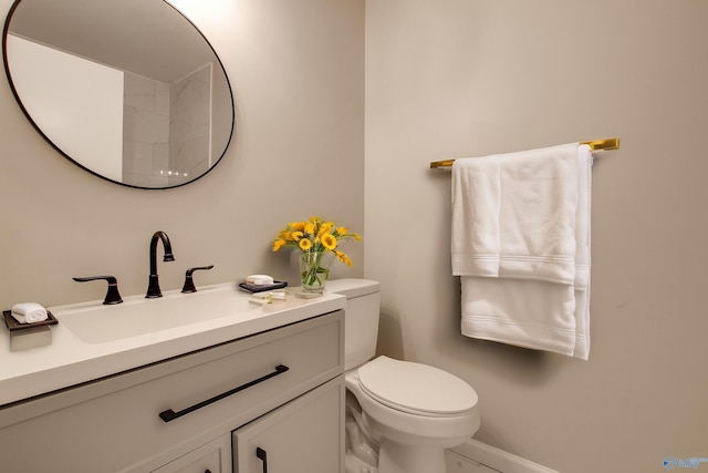 bathroom featuring toilet and vanity