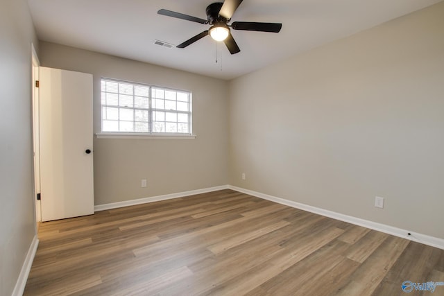 spare room with light hardwood / wood-style floors and ceiling fan