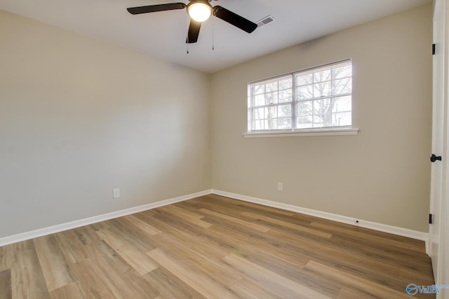 spare room with ceiling fan and light wood-type flooring