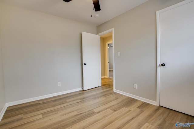 unfurnished bedroom with ceiling fan and light hardwood / wood-style floors