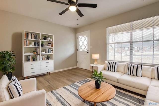 living room featuring ceiling fan and light wood-type flooring