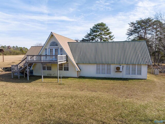 rear view of house with a yard and a deck