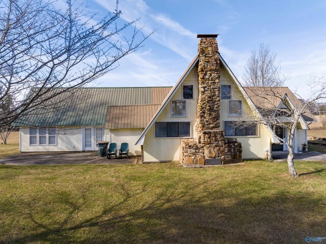 rear view of house with a lawn