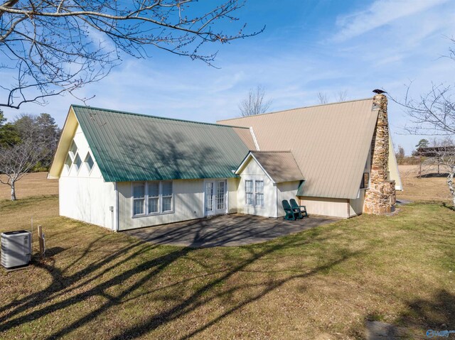 exterior space featuring cooling unit and a yard