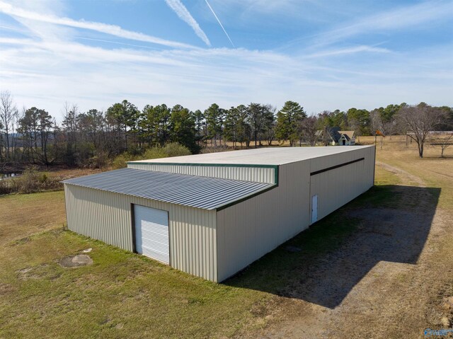 view of outbuilding featuring a garage and a yard